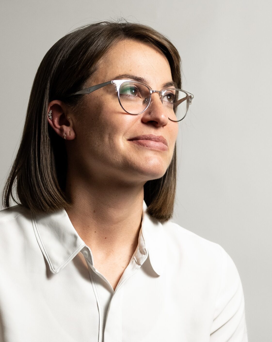 headshot of woman wearing glasses and white button up shirt